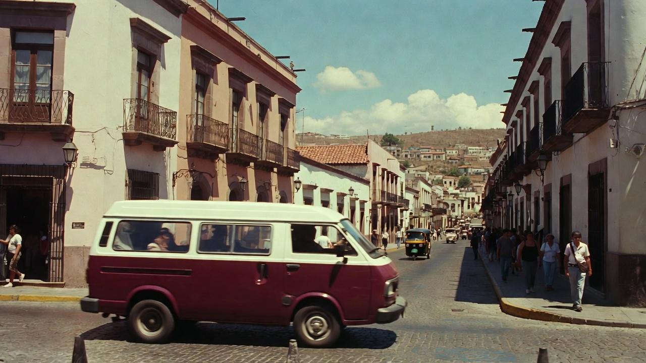 People walking on a sunny street under a clear blue sky